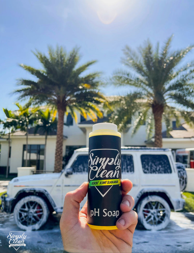 Simply Clean pH Soap Bottle Image with a car in the background with pH soap on it.